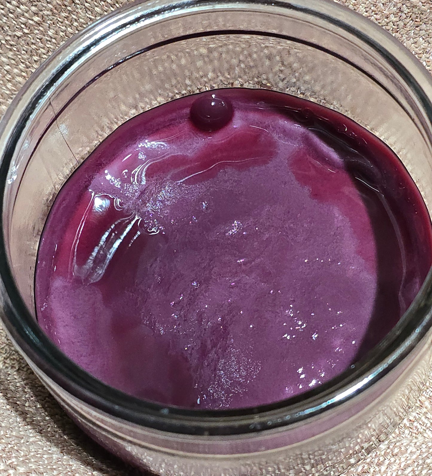 Probiotic red wine vinegar mother SCOBY fermenting in a glass jar.